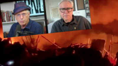Andy Zee and Alan Goodman with Israeli bombing of Rafah in the background