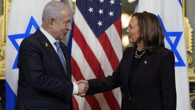 Benjamin Netanyahu and Kamala Harris shake hands.