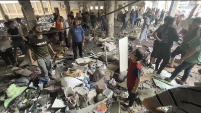 Inspecting the damaged roof of a school in Gaza City, damaged by Israeli airstrike, August 10, 2024.