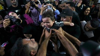 Mourners carry six-month-old orphan in Nablus, August 15, 2024.