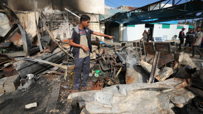 Mohamed al-Dalu points to where his brother, Shaban, burned to death when an Israeli airstrike ignited refugee tents at Al Aqsa Martyrs hospital in the Gaza Strip, October 16, 2024.