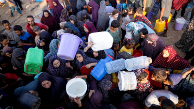 Displaced Palestinians queue for water at makeshift tent camp in Khan Younis, July 1, 2024.