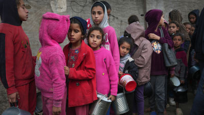 Palestinian children queue for food at a center in Deir al-Balah, Gaza Strip, November 28, 2024.