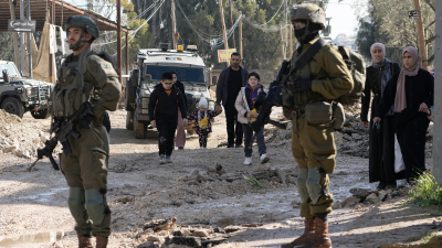 Palestinians displaced by an Israeli military strike on the Jenin refugee camp in the West Bank carry their belongings, January 23, 2025.