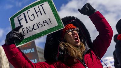 Woman with sign Stop Fascism, Ypsilanti, Michigan, February 17, 2025.