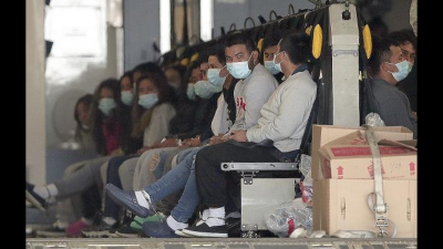 Migrants, shackled, sit on a military aircraft at Fort Bliss in El Paso, Texas, January 30, 2025.