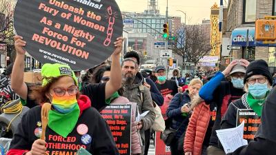 International Women's Day march in Harlem. Sign: Break the Chains Unleash the Fury of Women as a Mighty Force for Revolution!