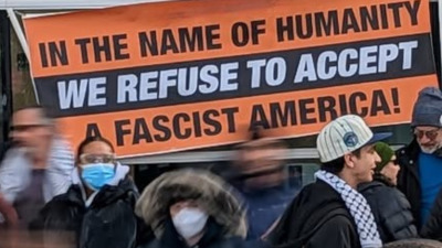 Banner: In the Name of Humanity, We Refuse to Accept a Fascist America!