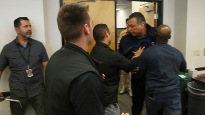 Senator Alex Padilla being pushed out of the room by police, at the news conference of Homeland Security Secretary Kristi Noem, Los Angeles, June 12, 2025.