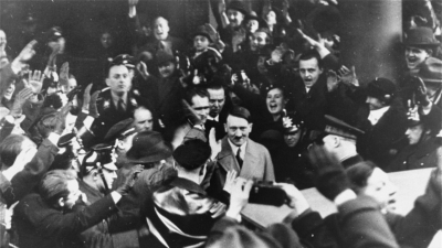 Germans cheer Adolf Hitler as he leaves the Hotel Kaiserhof just after being sworn in as chancellor. Berlin, Germany, January 30, 1933.