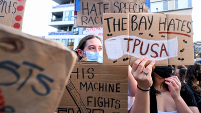 Protesters with signs stand outside a Turning Point USA event at the University of California, Berkeley, November 10, 2025