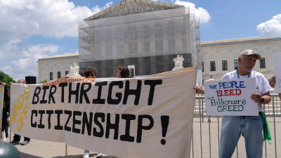Demonstrators hold up a “Birthright Citizenship” banner at the Supreme Court in Washington, May 15, 2025.