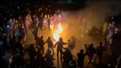 Screengrab from AP video of protesters dancing around fire in Iran, January 9, 2026.