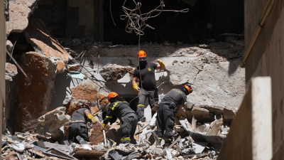 Lebanese workers search through rubble from Israeli airstrike for the body of missing student, April 11, 2026.