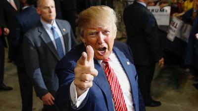 Donald Trump pointing his finger like a gun.