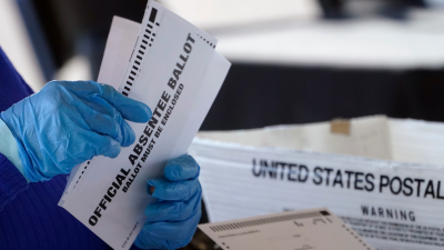 Fulton Co., GA election worker processes absentee ballots, November 2, 2020