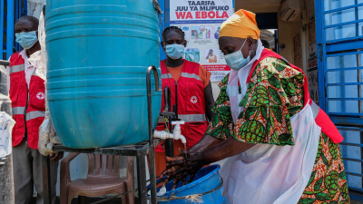 A health worker washes her hands at a temporary health clinic at a border crossing between Uganda and the Democratic Republic of the Congo, June 4, 2026.