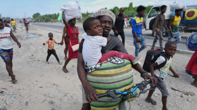 Haitians flee their homes to escape clashes between armed gangs in Port-au-Prince, Haiti, May 11, 2026.