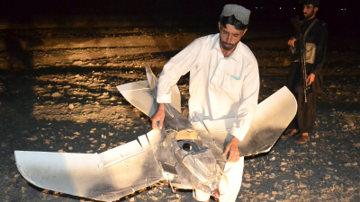 A Pakistani villager holds the wreckage of a U.S. drone that crashed along the border with Afghanistan, August 25, 2011.