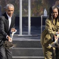 Barack and Michelle Obama shovel dirt for their library in Chicago.