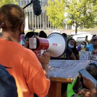 September 26, 2022: A woman whose brother was one of three inmates to die from medical neglect in the last two months at the Bibb “Correctional Facility” speaks at a "Break All the Chains" rally outside the Alabama State House in Montgomery.