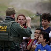 Immigrants who crossed the Rio Grande are stopped by Border Patrol, May 22, 2022.