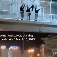 Three women on a pedestrian bridge over a highway in Tehran, waving their headscarves and chanting “Death to the dictator!” March 15, 2023 (Twitter: @1500tasvir)