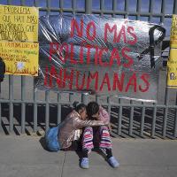 Venezuelan sisters outside immigration center where dozens of migrants were killed in fire.