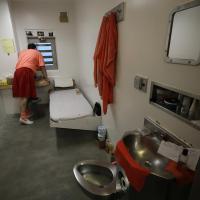 Inmate looks out window in a solitary confinement cell in the main jail in San Jose.
