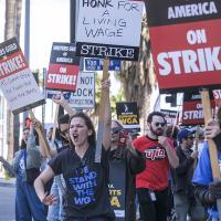Members of the The Writers Guild of America (WGA) picket outside the Netflix, Inc., building on Sunset Blvd, on Friday, May 5, 2023, in Los Angeles.