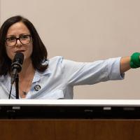 Sunsara Taylor points while speaking, "Woke Lunacy vs Real Revolution" talk at UCLA, May 25, 2023.