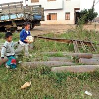 Children play near cluster bombs in Laos, 1997.