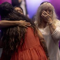 Attendees embrace during a church service for victims of the fire in Hawai'i