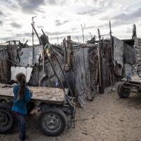 Palestinian woman stands near her house on the outskirts of Khan Younis Refugee Camp in the southern Gaza Strip, November 2020.