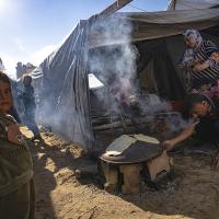 People in tents cooking at a Gaza Strip refugee camp, November 15, 2023.