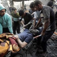 Injured man in Khan Younis refugee camp pulled from rubble, November 18, 2023.