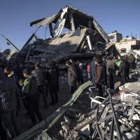 Palestinians search for survivors in the rubble of a residential building destroyed by an Israeli airstrike, in Rafah, December 15, 2023.