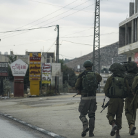 Israeli soldiers patrol a Palestinian town, with the residents all driven out by "settler" violence