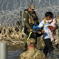 Migrants crossing the border at Eagle Pass, Texas are taken into custody by the officials, January 3, 2024.