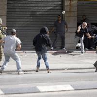 Palestinians and Israeli settlers clash in West Bank, October 13, 2022.