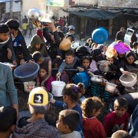 Thousands of Palestinians wait for food trucks in Rafah, March 12, 2024.