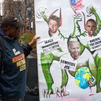 New York City, Radio City protest: poster of Genocide Joe, Barack the Drone Ranger, and Mass Incarceration Bill Clinton, March 28, 2024.