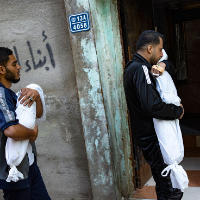 Members of the Abu Draz family hold the bodies of their relatives killed in the Israeli bombardment of the Gaza Strip, at their house in Rafah, southern Gaza, Thursday, April 4, 2024.