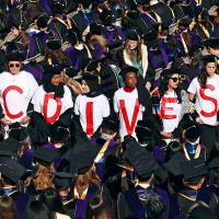  UC Berkeley Law School graduates wear T-shirts that read "UC DIVEST" during commencement, May 10, 2024.