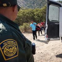 Immigrants seeking asylum are met by Border Patrol as they approach the U.S.-Mexico border, June 5, 2024.