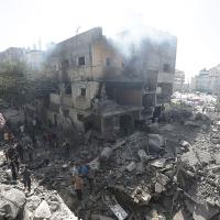 Palestinians look at the rubble from the Israeli bombing in Nuseirat refugee camp, Gaza Strip, June 8, 2024