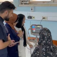 Dr. Majed Jaber (in blue vest) treating patients at European Gaza Hospital, June 2024.