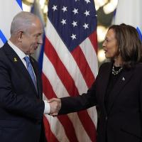 Benjamin Netanyahu and Kamala Harris shake hands.