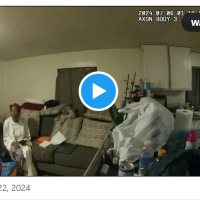 Sonya Massey in her home with cop standing near.