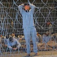 Blindfolded Palestinian prisoners captured in Gaza by Israeli forces, at the Sde Teiman military base in southern Israel, winter 2023. (Photo: breakingthesilence.org.il)